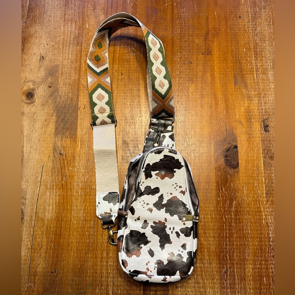 Only used once, gorgeous cow print sling bag.